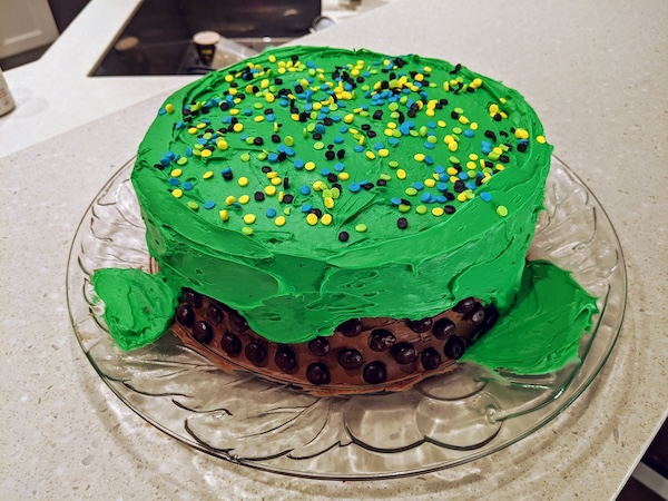Cake green frosting made to look like slime with candy everywhere else